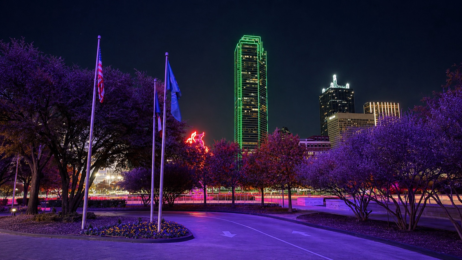 Bank of America Plaza lit green at night over downtown Dallas, MarketScale's HQ